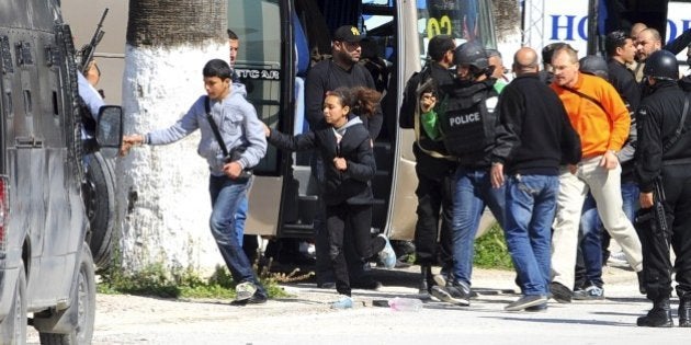 Tourists and visitors from the Bardo museum are evacuated in Tunis, Wednesday, March 18, 2015 in Tunis, Tunisia. Gunmen opened fire at a leading museum in Tunisia's capital, killing 19 people including 17 tourists, the Tunisian Prime Minister said. A later raid by security forces left two gunmen and one security officer dead but ended the standoff, Tunisian authorities said. (AP Photo/Hassene Dridi)