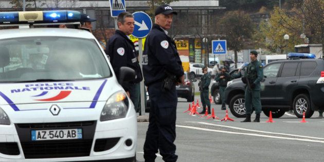French police officers, right, and Spanish Guardia Civil policemen stand at the border crossing between France and Spain in Behobie, southwestern France, Saturday, Nov. 14, 2015. Some 1,500 extra soldiers have been mobilized to guard key sites around Paris, including Parliament buildings and religious sites. The government has also re-imposed border controls that were abandoned as part of Europe's free-travel zone. (AP Photo/Bob Edme)