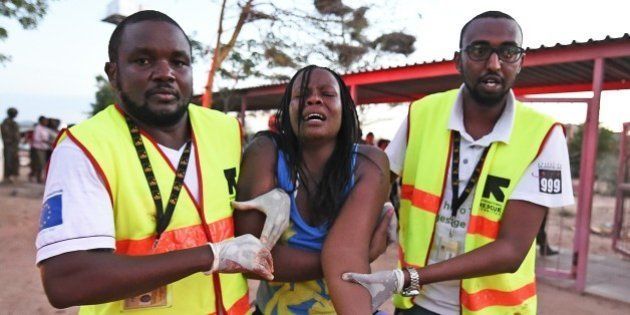Paramedics help a student who was injured during an attack by Somalia's Al-Qaeda-linked Shebab gunmen on the Moi University campus in Garissa on April 2, 2015. At least 70 students were massacred when Somalia's Shebab Islamist group attacked a Kenyan university today, the interior minister said, the deadliest attack in the country since US embassy bombings in 1998. AFP PHOTO / CARL DE SOUZA (Photo credit should read CARL DE SOUZA/AFP/Getty Images)