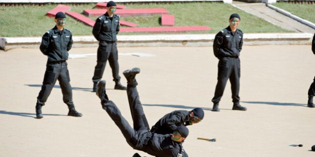 In a picture taken on September 23, 2010 Chinese anti-terrorism police S.W.A.T. unit members show off their hand-to-hand combat skills during an exercise on the outskirts of Beijing. The Beijing police S.W.A.T. unit was established in 2005 to deal with terrorism and riot control particularly during the Beijing Olympics and unrest in Xinjiang. CHINA OUT AFP PHOTO (Photo credit should read STR/AFP/Getty Images)