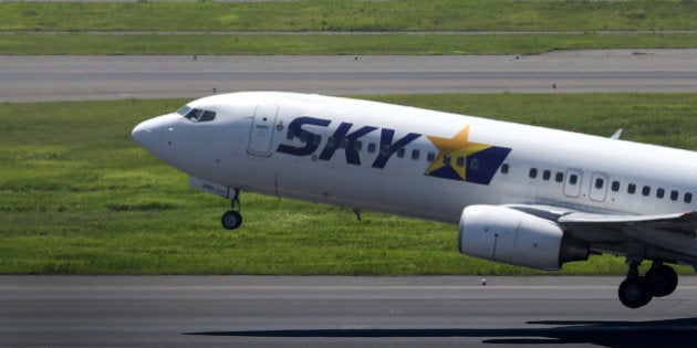 A Skymark Airlines Inc. aircraft takes off at Haneda Airport in Tokyo, Japan, on Wednesday, Aug. 20, 2014. Skymark Airlines gained the most in almost six years in Tokyo trading on Aug. 19 as AirAsia Bhd. was said to be considering support, including taking a stake in the airline. Photographer: Tomohiro Ohsumi/Bloomberg via Getty Images