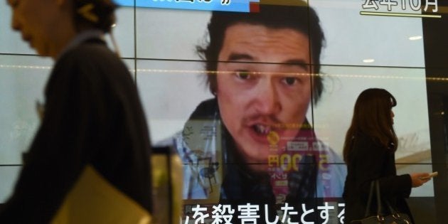 People walk past a big screen reporting that a Japanese hostage was killed by the Islamic State in Tokyo on February 1, 2015. Japan said it was 'outraged' after the Islamic State group released a video purportedly showing the beheading of Japanese hostage Kenji Goto. AFP PHOTO / Toru YAMANAKA (Photo credit should read TORU YAMANAKA/AFP/Getty Images)