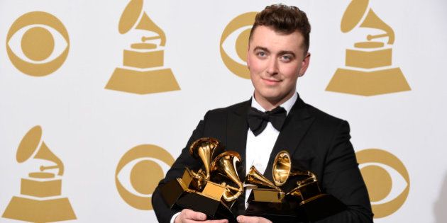 Sam Smith poses in the press room with the awards for best new artist, best pop vocal album for âIn the Lonely Hourâ, song of the year for âStay With Meâ, and record of the year for âStay With Meâ at the 57th annual Grammy Awards at the Staples Center on Sunday, Feb. 8, 2015, in Los Angeles. (Photo by Chris Pizzello/Invision/AP)