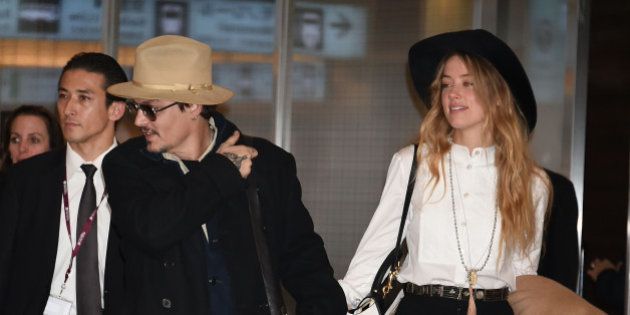 TOKYO, JAPAN - JANUARY 26: Johnny Depp and Amber Heard are seen upon arrival at Haneda Airport on January 26, 2015 in Tokyo, Japan. (Photo by Jun Sato/GC Images)