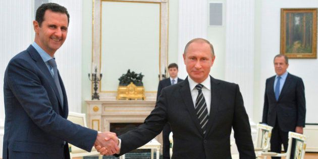 In this photo taken on Tuesday, Oct. 20, 2015, Russian President Vladimir Putin, center, shakes hand with Syrian President Bashar Assad as Russian Foreign Minister Sergey Lavrov, right, looks on in the Kremlin in Moscow, Russia. President Bashar Assad was in Moscow, in his first known trip abroad since the war broke out in Syria in 2011, to meet his strongest ally Russian leader Vladimir Putin. The two leaders stressed that the military operations in Syria_ in which Moscow is the latest and most powerful addition_ must lead to a political process. (Alexei Druzhinin, RIA-Novosti, Kremlin Pool Photo via AP)