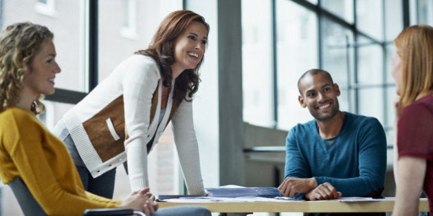 Smiling coworkers in meeting in modern studio