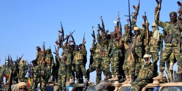 Chadian soldiers gather on February 1, 2015 near the Nigerian town of Gamboru, just accros the border from Cameroon. In a deserted Gamboru, Chadian forces carried out clean-up operations after entering the town and retaking it from Boko Haram, which seized control months ago. AFP PHOTO / MARLE (Photo credit should read MARLE/AFP/Getty Images)