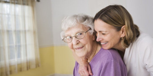 Daughter hugging Elderly mother