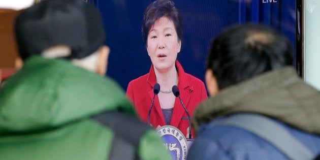 People watch a live broadcast of South Korean President Park Geun-hye's New Year press conference at the Seoul Railway Station in Seoul, Monday, Jan. 12, 2015. (AP Photo/Lee Jin-man)