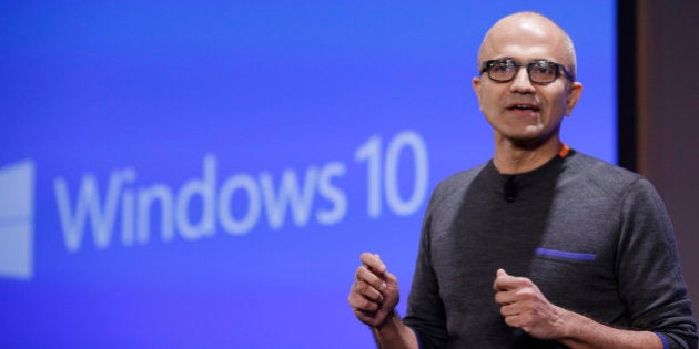 Microsoft CEO Satya Nadella speaks at an event demonstrating new features of its flagship operating system Windows at the company's headquarters Wednesday, Jan. 21, 2015, in Redmond, Wash. Executives demonstrated how they said the new Windows is designed to provide a more consistent experience and a common platform for software apps on different devices, from personal computers to tablets, smartphones and even the company's Xbox gaming console. (AP Photo/Elaine Thompson)