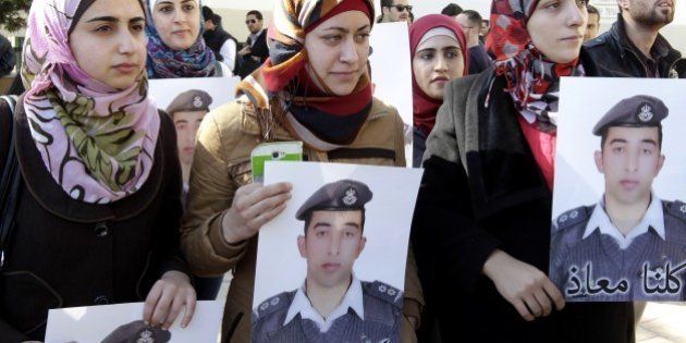 Anwar Tarawneh (C), the wife of Jordanian pilot Maaz al-Kassasbeh, who was captured by Islamic State (IS) group militants on December 24 after his F-16 jet crashed while on a mission against the jihadists over northern Syria, takes part in a rally calling for the release of her captive husband in the Jordanian capital Amman on February 3, 2015. Jordan vowed to do all it could to save the pilot held by IS after the jihadists killed a Japanese journalist they had been holding. IS has been demanding the release of an Iraqi jihadist on death row in Jordan in exchange for Kassasbeh's life, and Amman said it would hand her over if given proof that he is still alive. AFP PHOTO / KHALIL MAZRAAWI (Photo credit should read KHALIL MAZRAAWI/AFP/Getty Images)