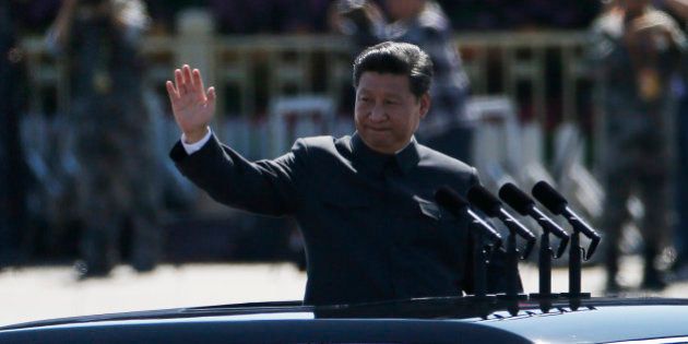 Chinese President Xi Jinping stands in a car and waves during a troop review during a parade commemorating the 70th anniversary of Japan's surrender during World War II held in front of Tiananmen Gate in Beijing, Thursday, Sept. 3, 2015.The spectacle involved more than 12,000 troops, 500 pieces of military hardware and 200 aircraft of various types, representing what military officials say is the Chinese military's most cutting-edge technology. (AP Photo/Ng Han Guan)