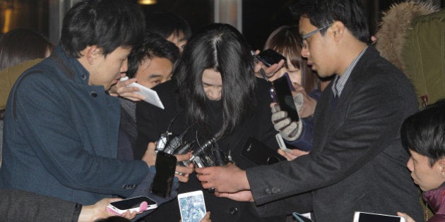 SEOUL, SOUTH KOREA - DECEMBER 30: Former Korean Air Lines Co. Vice President Cho Hyun-Ah (C), leaves the Seoul western prosecutors' office as she is transferred to a detention house on December 30, 2014 in Seoul, South Korea. The Seoul court has decided on December 30, 2014 to issue an arrest warrant for Cho, who resigned as vice president after it was reported she had delayed a flight from take off and insisted that the plane return to the gate after being served a package of macadamia nuts. (Photo by Chung Sung-Jun/Getty Images)