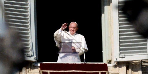 Pope Francis waves to the crowd from the window of the pope's biblioteque, during the Sunday Angelus prayer in St Peter's square at the Vatican on January 4, 2015. The pontiff announced that, on February 14, he will nominate twenty new cardinals, fifteen from 14 countries, aged less than 80 years and therefore voters in case of new conclave. AFP PHOTO / VINCENZO PINTO (Photo credit should read VINCENZO PINTO/AFP/Getty Images)
