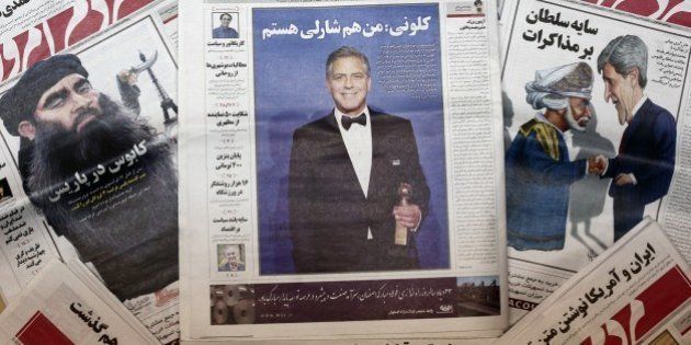 A picture taken in Tehran shows copies of the headline of Iranian reformist newspaper Mardom-e Emrouz (People of Today) on January 17, 2015 as well as it's January 13 front page edition with a picture of Hollywood star George Clooney with the headline of his quote 'I am Charlie.' Iran has banned the Mardom-e Emrouz reformist newspaper for publishing the quote from Clooney who told the audience 'Je suis Charlie' (I am Charlie) at the Golden Globe Awards on January 12 as he received an award for his film career. AFP PHOTO / BEHROUZ MEHRI (Photo credit should read BEHROUZ MEHRI/AFP/Getty Images)