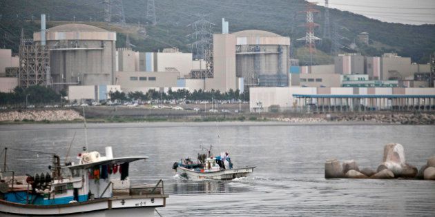 A fishing boat moves toward the Korea Hydro & Nuclear Power Co. (KHNP) Wolsong Nuclear Power Plant standing by the shore in Gyeongju, South Korea, on Tuesday, June 25, 2013. South Koreas government urged efforts to conserve electricity as the nation faces shortages following shutdowns in a nuclear power industry that supplies 30 percent of the nations generating capacity. Photographer: Jean Chung/Bloomberg via Getty Images