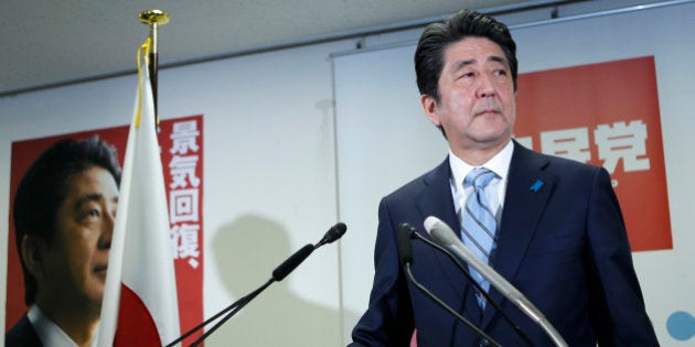 Shinzo Abe, Japan's prime minister and president of the ruling Liberal Democratic Party (LDP), stands for a photograph as he arrives for a news conference at the party's headquarters in Tokyo, Japan, on Monday, Dec. 15, 2014. Prime Minister Shinzo Abe claimed a mandate for his economic program after his gamble on early elections paid off with a sweeping victory that forced the leader of the opposition to resign. Photographer: Kiyoshi Ota/Bloomberg via Getty Images