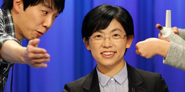 South Korea's presidential candidate Lee Jung-Hee (C) of the opposition Unified Progressive Party talks with a staff member of a TV station before a televised debate in Seoul on December 4, 2012. Conservative and right wing Park who is the daughter of late South Korean military dictator Park Chung-hee and the former human rights lawyer Moon, participated in a debate over security policy as North Korea readied a rocket launch that is timed to coincide with the South's presidential election. AFP PHOTO / POOL (Photo credit should read LEE JAE-WON/AFP/Getty Images)