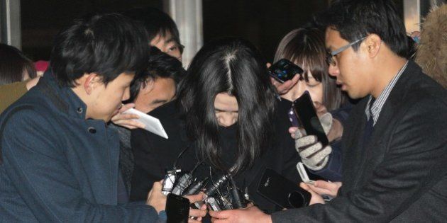 Cho Hyun-ah, top center, the former vice president of Korean Air, is surrounded by reporters before leaving for the prison at the Seoul Western District Prosecutors Office in Seoul, South Korea, Tuesday, Dec. 30, 2014. A South Korean court has approved the arrest of a former Korean Air Lines Co. executive who delayed a flight in what has widely been called