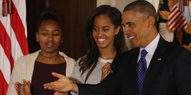 WASHINGTON, DC - NOVEMBER 26: U.S. President Barack Obama (R) speaks as his daughters Sasha (L) and Malia (R) look on after pardoning 'Cheese' and his alternate Mac both, 20-week old 48-pound Turkeys, during a ceremony at the White House November 26, 2014 in Washington, DC. The Presidential pardon of a turkey has been a long time Thanksgiving tradition that dates back to the Harry Truman administration.(Photo by Mark Wilson/Getty Images)