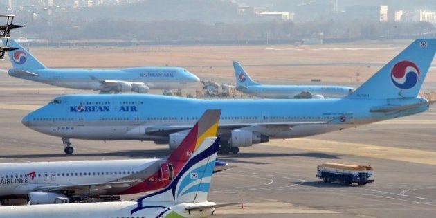 South Korea's Korean Air plane (C) sits on the tarmac at Gimpo airport in Seoul on December 9, 2014. Korean Air apologised as it faced a media backlash over the daughter of the airline's CEO, who had a chief purser ejected from a plane in a furious reaction to being incorrectly served some macadamia nuts. AFP PHOTO / JUNG YEON-JE (Photo credit should read JUNG YEON-JE/AFP/Getty Images)