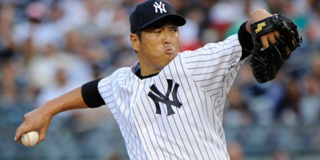 New York Yankees pitcher Hiroki Kuroda delivers the ball to the Toronto Blue Jays during the first inning of a baseball game Friday, July 25, 2014, at Yankee Stadium in New York. (AP Photo/Bill Kostroun)