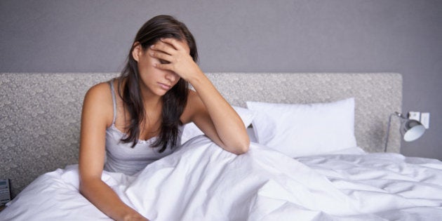 Shot of an attractive young woman sitting on her bed looking unhappyhttp://195.154.178.81/DATA/i_collage/pi/shoots/783637.jpg