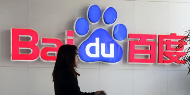 A woman walks past the Baidu Inc. logo in the reception are of the company's headquarters in Beijing, China, on Wednesday, Nov. 12, 2014. While Beijing-based Baidu, owner of China's most-used search-engine, is available around the world, more than 99 percent of its revenue comes from China. Photographer: Tomohiro Ohsumi/Bloomberg via Getty Images