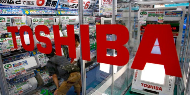 In this photo taken Monday, July 20, 2015, shoppers look at air conditioners displayed at an electronics store in Tokyo. Toshiba Corp. CEO Hisao Tanaka stepped down Tuesday, July 21, 2015 to take responsibility for doctored books that inflated profits at the Japanese technology manufacturer by 151.8 billion yen ($1.2 billion). Toshiba acknowledged a systematic cover-up, which began in 2008, as various parts of its sprawling business including computer chips and personal computers were struggling financially, but top managers set unrealistic earnings targets under the banner of âchallenge.â (AP Photo/Shizuo Kambayashi)