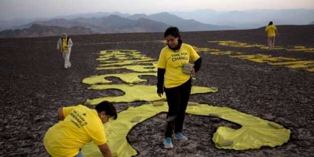 Greenpeace activists arrange the letters delivering the message