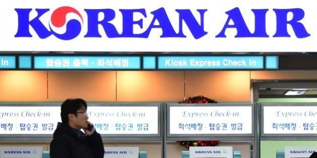 A man talks over his mobile phone in front of the logo of Korean Air at Gimpo airport in Seoul on December 9, 2014. Korean Air apologised as it faced a media backlash over the daughter of the airline's CEO, who had a chief purser ejected from a plane in a furious reaction to being incorrectly served some macadamia nuts. AFP PHOTO / JUNG YEON-JE (Photo credit should read JUNG YEON-JE/AFP/Getty Images)