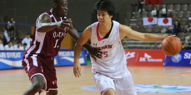 Qatar's Erfan Ali Saeed (L) guards against Japan's Joji Takeuchi (R) in their men's basketball preliminary round match during the 17th Asian Games at the Hwaseong Sports Complex Gymnasium in Incheon on September 25, 2014. QATAR OUT AFP PHOTO / AL-WATAN DOHA / KARIM JAAFAR (Photo credit should read KARIM JAAFAR/AFP/Getty Images)