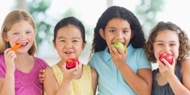 USA, New Jersey, Jersey City, Portrait of girls (6-9) eating fruits