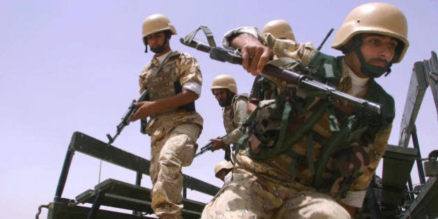 BASRA, Iraq: Iraqi soldiers jump off the back of a truck as they take part in a training session some 15 kms outside of the southern city of Basra, 500 kms from Baghdad 07 June 2005. A fledgling Iraqi army is being put through its paces with daily violence across the country. Global military spending blasted past the trillion dollar mark in 2004, with the United States alone accounting for nearly half of the total because of its 'war on terror', the Stockholm International Peace Research Institute (SIPRI) said today. AFP PHOTO/ESSAM AL-SUDANI (Photo credit should read ESSAM AL-SUDANI/AFP/Getty Images)