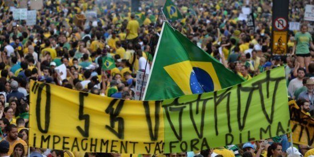 Demonstrators rally to protest against the government of president Dilma Rousseff in Paulista Avenue in Sao Paulo Brazil on 15 March 2015. Thousands of demonstrators clad in the yellow-green national colours protested Sunday in several cities of Brazil against president Dilma Rousseff who is facing a complex economic panorama and a political corruption scandal. AFP PHOTO / NELSON ALMEIDA (Photo credit should read NELSON ALMEIDA/AFP/Getty Images)