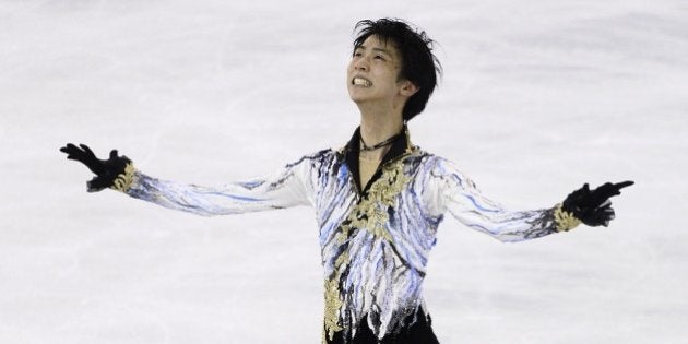 Yuzuru Hanyu, of Japan, celebrates after wining the Men Free Skating at the Grand Prix Final figure skating competition in Barcelona, Spain, Saturday, Dec. 13, 2014. (AP Photo/Manu Fernandez)