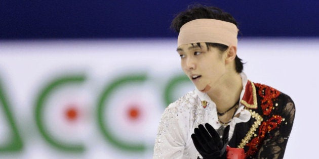 Sochi Winter Olympics men's figure skating gold medalist Yuzuru Hanyu of Japan performs during the men's free stake at the Cup of China in Shanghai, China Saturday, Nov. 8, 2014. Hanyu clashed with Yan Han of China during a practice prior to the performance. (AP Photo/Kyodo News) JAPAN OUT, MANDATORY CREDIT