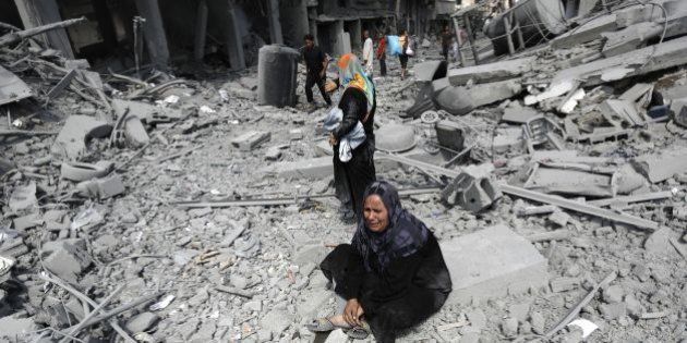 A Palestinian woman reacts at seeing destroyed homes in the northern district of Beit Hanun in the Gaza Strip during an humanitarian truce on July 26, 2014. Palestinians retrieved dozens of bodies from the rubble of Gaza homes during a brief truce in the fighting, raising to over 900 the overall death toll of Israel's onslaught on the territory since July 8, medics said. AFP PHOTO / MOHAMMED ABED (Photo credit should read MOHAMMED ABED/AFP/Getty Images)