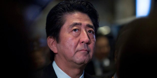 Shinzo Abe, Japan's prime minister, visits the trading floor at the New York Stock Exchange (NYSE) in New York, U.S., on Wednesday, Sept. 25, 2013. Abe's pledge to end 15 years of deflation and the Bank of Japan's monetary policy easing, along with Tokyo's winning bid to host the 2020 Olympic Games have helped boost consumer sentiment. Photographer: Scott Eells/Bloomberg via Getty Images