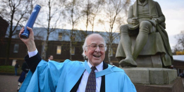 EDINBURGH, SCOTLAND - NOVEMBER 16: Professor Peter Higgs, poses for photographs in front of a statue of James Watt after receiving an honorary degree of doctor of science, from Heriot-Watt University on November 16, 2012 in Edinburgh, Scotland. Professor Peter Higgs, the scientist who postulated and gave his name to the recently discovered Higgs boson, the so called god particle, received the degree in recognition of his pioneering and greatly influential contribution to physics.(Photo by Jeff J Mitchell/Getty Images)