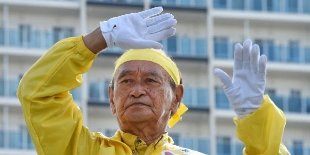 Incumbent governor Hirokazu Nakaima waves to people during his stumping tour for the Okinawa gubernatorial election in Naha on November 15, 2014. Voters in Japan's far southern Okinawa are braced for the gubernatorial election on November 16, with polls showing an anti-US base candidate Onaga having a lead, an obstacle for Prime Minister Shinzo Abe's efforts to boost alliance with Washington. AFP PHOTO / Toru YAMANAKA (Photo credit should read TORU YAMANAKA/AFP/Getty Images)