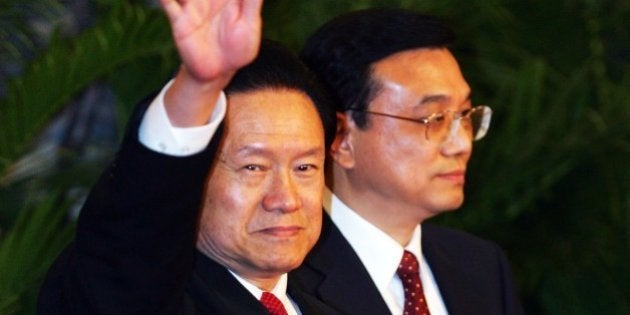 BEIJING - OCTOBER 22: Zhou Yongkang, one of the new nine-seat Politburo Standing Committee, greets the media at the Great Hall of the People on October 22, 2007 in Beijing. China's ruling Communist Party today revealed the new nine-seat Politburo Standing Committee after its 17th congress. (Photo by Feng Li/Getty Images)