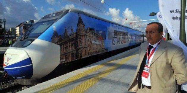 A man stands by the first Turkish high-speed train at Pendik railway station, in Istanbul, during the high-speed train opening cerenomy on July 25, 2014. Turkish Prime Minister Recep Tayyip Erdogan inaugurated the first high-speed train link between Ankara and Istanbul on July 25, 2014, his latest ambitious grand engineering project, but arrived late after a technical problem on the maiden trip. AFP PHOTO / OZAN KOSE (Photo credit should read OZAN KOSE/AFP/Getty Images)