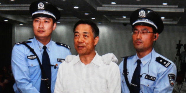 BEIJING, CHINA - SEPTEMBER 22: A screen shows the picture of the sentence of Chinese politician Bo Xilai (Center) on September 22, 2013 in Beijing, China. The Jinan Intermediate People's Court announced Bo Xilai, former member of the CPC Central Committee Political Bureau, was sentenced to life imprisonment on Sunday for bribery, embezzlement and abuse of power. (Photo by Feng Li/Getty Images)