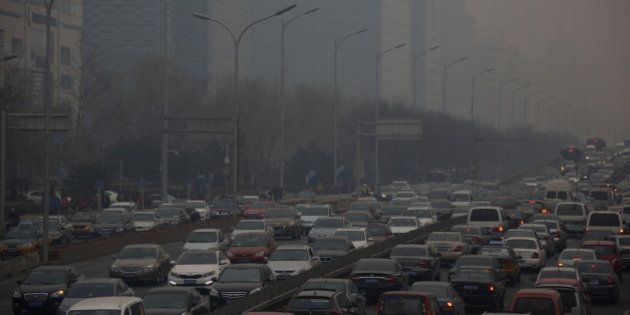 Traffic moves along a street shrouded in haze in Beijing, China, on Friday, March 15, 2013. China's new premier promised to crack down on corruption and clean up pollution, acknowledging the need to tackle two issues that have stoked public anger toward the country's leaders. Photographer: Tomohiro Ohsumi/Bloomberg via Getty Images