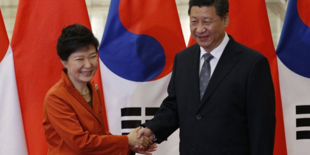 BEIJING, CHINA - NOVEMBER 10: China's President Xi Jinping (R) shakes hands with South Korea's President Park Geun-hye in front of Chinese and South Korean national flags during a meeting at the Great Hall of the People, on the sidelines of the Asia Pacific Economic Cooperation (APEC) meetings, November 10, 2014 in Beijing, China. APEC Economic Leaders' Meetings and APEC summit is being held at Beijing's outskirt Yanqi Lake. (Photo by Kim Kyung-Hoon-Pool/Getty Images)