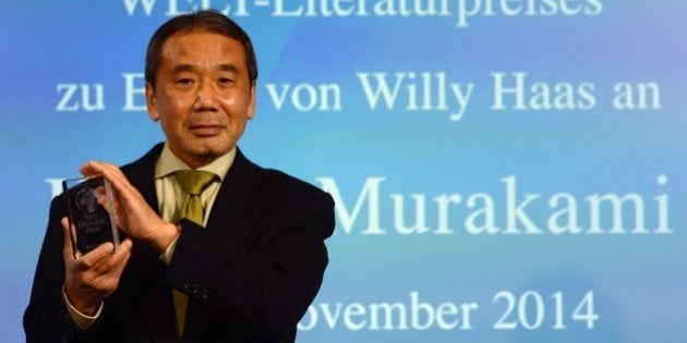 Japanese writer Haruki Murakami poses with his trophy prior to an award ceremony for the Germany's Welt Literature Prize bestowed by the German daily Die Welt, in Berlin on November 7, 2014. AFP PHOTO / JOHN MACDOUGALL (Photo credit should read JOHN MACDOUGALL/AFP/Getty Images)