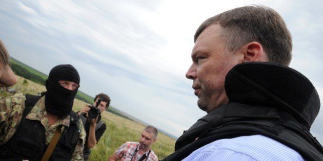 Alexander Hug, (R) Deputy Chief Monitor of the Organization for Cooperation and Security in Europe's (OSCE) Special Monitoring Mission to Ukraine, talks with a Pro-Russian separatist at the site of the crash of a Malaysian airliner carrying 298 people from Amsterdam to Kuala Lumpur in Grabove, in rebel-held east Ukraine, on July 18, 2014. Members of the UN Security Council demanded a full, independent investigation into the apparent shooting down of a Malaysia Airlines jet over Ukraine. AFP PHOTO / DOMINIQUE FAGET (Photo credit should read DOMINIQUE FAGET/AFP/Getty Images)