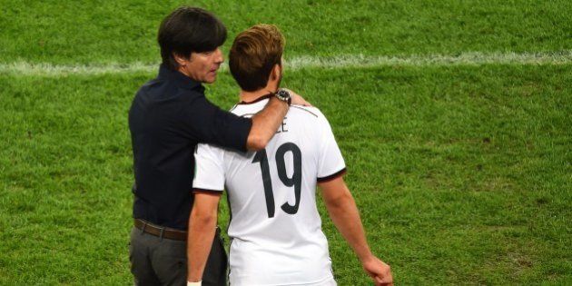 Germany's coach Joachim Loew (L) speaks with Germany's forward Mario Goetze as he comes on to play during the final football match between Germany and Argentina for the FIFA World Cup at The Maracana Stadium in Rio de Janeiro on July 13, 2014. AFP PHOTO / CHRISTOPHE SIMON (Photo credit should read CHRISTOPHE SIMON/AFP/Getty Images)