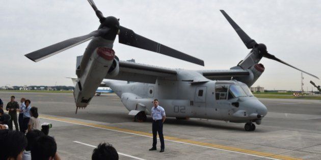 A US Marine Corps MV-22 Osprey is displayed in front of a hangar during a change of command ceremony at US Yokota Air Base in Tokyo on June 5, 2015. USAF Lieutenant General John Dolan, the new commander of US Forces Japan (USFJ), replaced outgoing commander Lt. Gen. Salvatore Angelella. AFP PHOTO / KAZUHIRO NOGI (Photo credit should read KAZUHIRO NOGI/AFP/Getty Images)